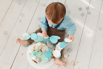 Little boy with a sweet cake in his hands. Focus on head