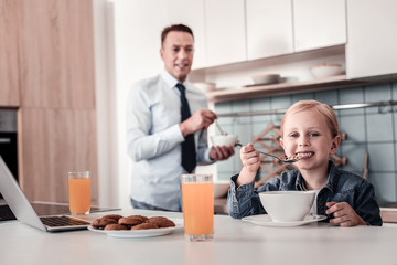 I like it. Silhouette of conscious father that expressing positivity while cooking breakfast and looking at his daughter