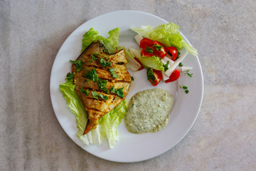 Cooked pumfret fish on a plate