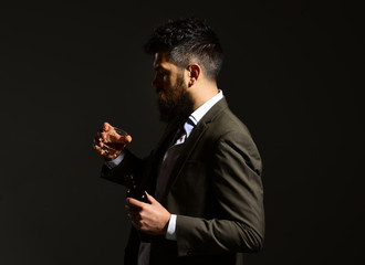 Drinking concept. Businessman with serious face in suit