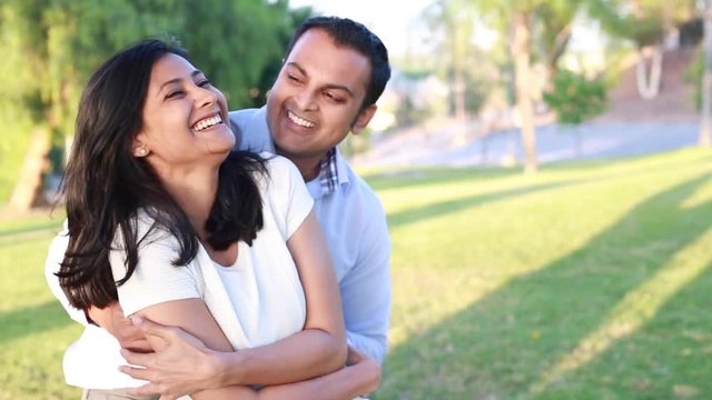 Closeup portrait, young couple in blue and white shirt, having fun with each other, isolated outdoors outside background. Happy moments, positive emotions