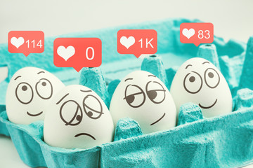 Happy eggs with many likes, one sad egg without likes. Social networks