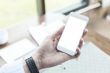 Hand using smartphone in office. Checking e-mail. Business smart connection technology.