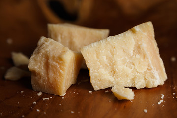 Parmesan cheese on a wooden board. Close-up.