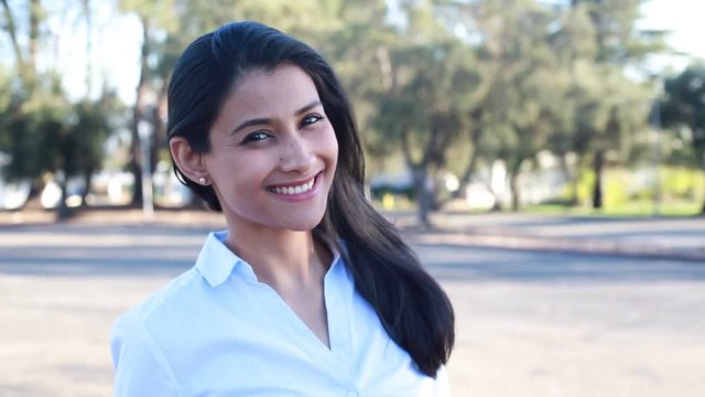 Closeup portrait, young businesswoman in blue shirt posing outdoors, isolated outside background. Positive human emotions