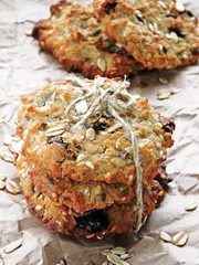 Homemade oatmeal cookies with raisins and sesame seeds and flax seeds. Fitness cookies. Oatmeal cookies and milk. The concept of a healthy breakfast with dietary oatmeal cookies.