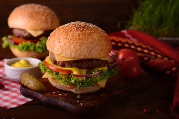 Fresh burger closeup. Wooden rustic background. Top view