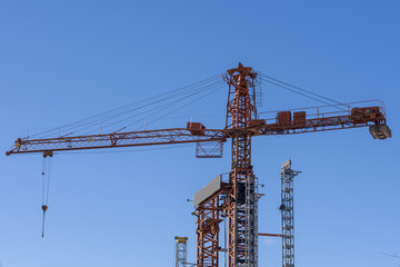 Big construction crane against  a blue sky