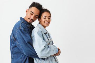 Portrait of a smiling young african couple hugging