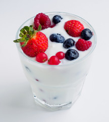 Glass with berries in milk. isolated background