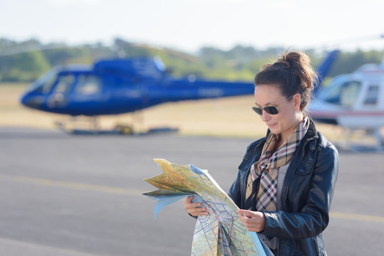 woman helicopter pilot reading map