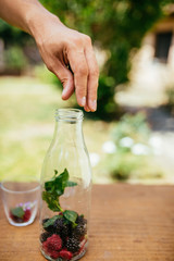 Placing Blackberry In Glass Bottle