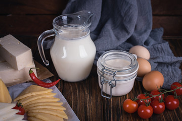 Farmers food products: milk, cream, cheese, eggs, cottage, butter. Rustic composition. Organic food concept