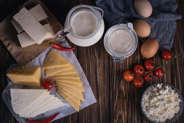 Farmers food products: milk, cream, cheese, eggs, cottage, butter. Rustic composition. Organic food concept