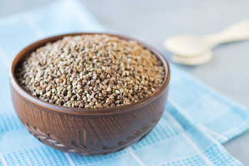 Buckwheat cereal in brown bowl.