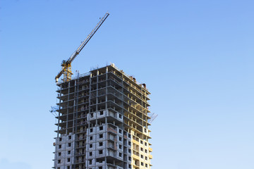Modern multi-storey building in the city on the shore on blue sky background