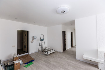 Unfinished building interior white room repairs in the apartment preparing in the room