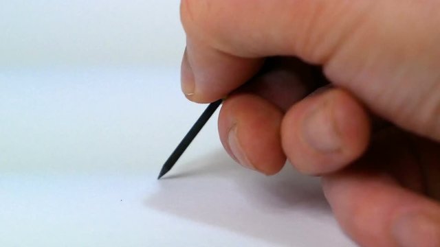 hand engraves on a white sheet with a burin