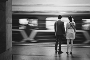 a pair of young people in the subway