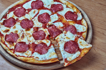 Homemade pizza pepperoni, traditional italian pizza, tomato sauce, mozzarella cheese, salami