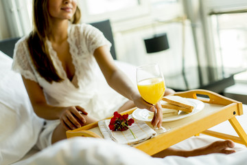 Breakfast in bed for young beautiful woman