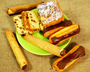  sweet wafer tubules with jam, cake with raisins, custard pies on a background of wood, raisins, cake, fresh, background, healthy, bakery, food, closeup, traditional, food, delicious, appetizer, desse