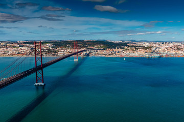 Fototapeta na wymiar The 25 April bridge (Ponte 25 de Abril) is a steel suspension bridge located in Lisbon, Portugal, crossing the Targus river. It is one of the most famous landmarks of the region.