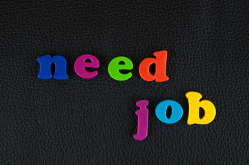 Need job written in   a mix of colourful plastic letters  on black leather. 