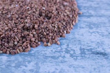 Buckwheat cereal on gray background. Copy space.