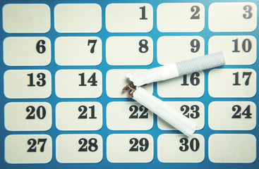 Broken cigarette in the calendar. Time to quit smoking