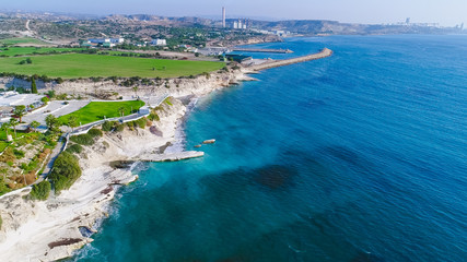 Aerial view of coastline and landmark big white chalk rock at Governor's beach,Limassol, Cyprus. Steep stone cliffs and deep blue sea waves next to Kalymnos fish restaurant and vasilikos power station