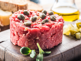 Steak tartare served with capers, pickled cucumbers and chopped onion.