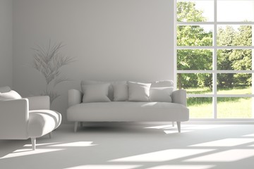 Fototapeta premium White room with sofa and green landscape in window. Scandinavian interior design. 3D illustration