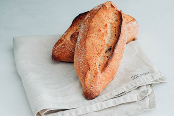 Different fresh bread, on white wooden table.
