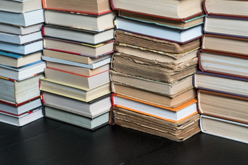 Many books in a bookstore or library on wooden background with copy space