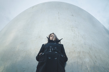 Young woman standing in futuristic curved minimalistic environment