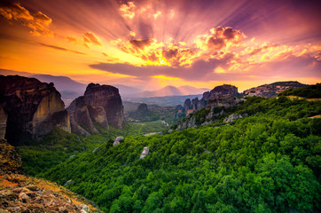 Breathtaking view of Meteora at sunset, Greece. Geological formations of big rocks with Monasteries  on top of them.
