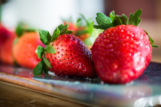 horizontal image fresh, ripe, red strawberries isolated, selective focus