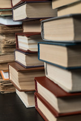 Many books in a bookstore or library on wooden background with copy space