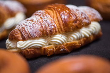 Cream croissant on dark background