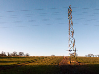 large metal tower field farm blue sky electric pylon communication power supply background