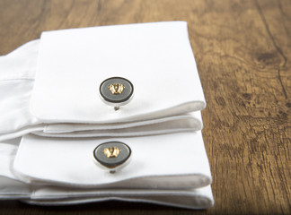 colorful cufflinks on the black and wooden background