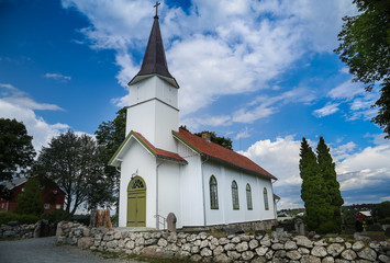 Fototapeta na wymiar Church in Norway on sunny weather and blue sky