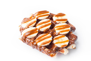 Belgian waffles with banana on white background