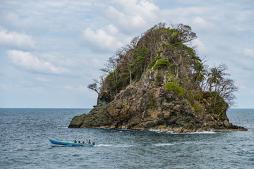 Naklejka premium small island , ocean and small boat