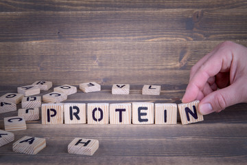 Protein. Wooden letters on the office desk, informative and communication background