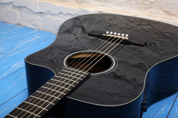 Musical instrument - Black cutaway electric acoustic guitar wood background