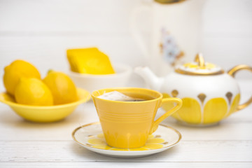 Bright Yellow Tea Set on a White Wood Table