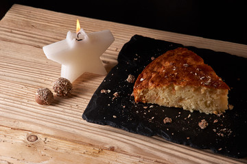Home baked apple pie on shale board and wooden table near Candle in the form of stars
