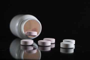 Tablets and pills on dark background. with a copy of space
